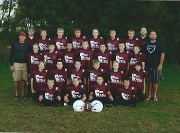 A group of young men in maroon shirts and helmets.