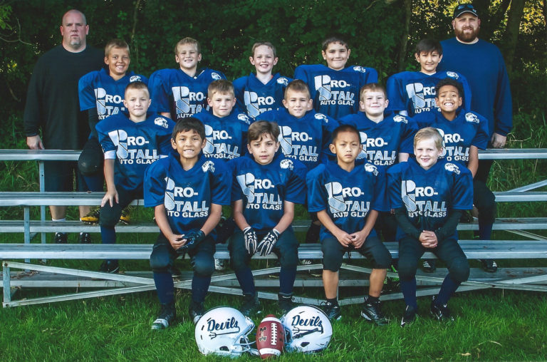 A group of young boys in blue football uniforms.